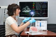 Annika Benson using her miscroscopic tool to help target brain tumours during surgery