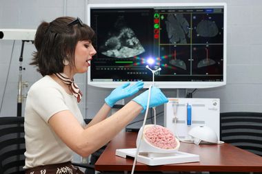 Annika Benson using her miscroscopic tool to help target brain tumours during surgery